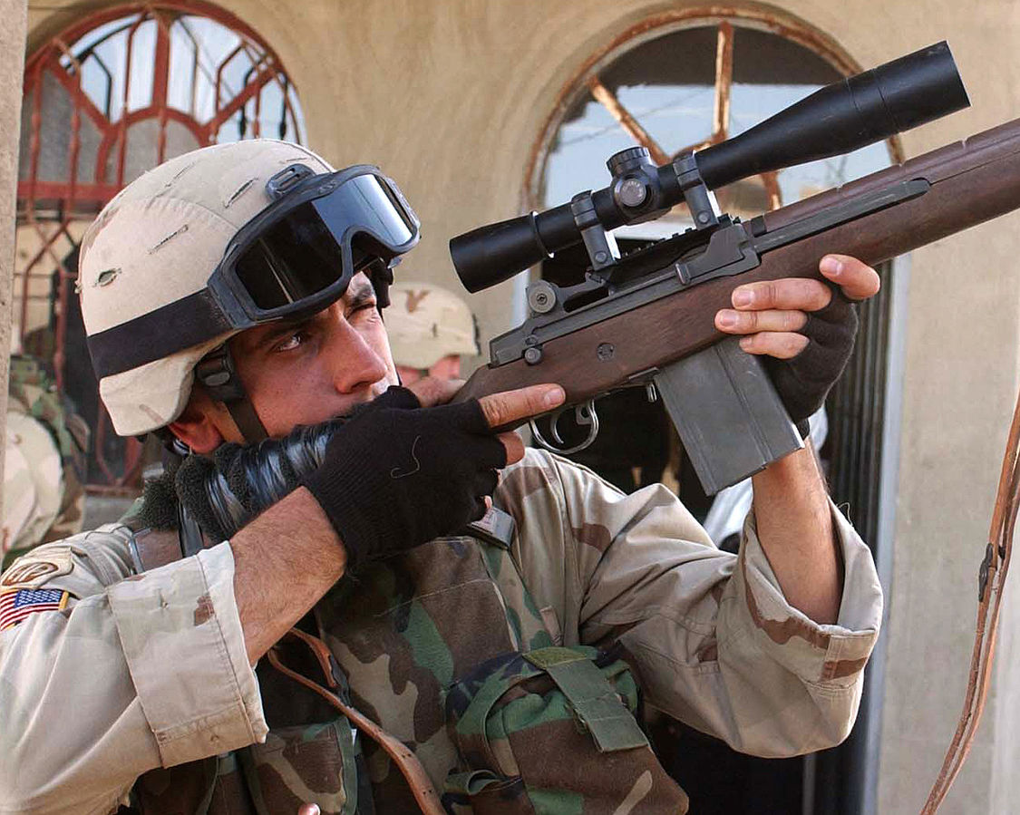 A sniper in Al Fallujah, Iraq with anM14 with a Leupold Mark 4 LR/T 10 x 40 mm M3